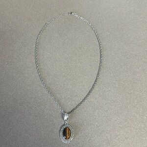 Avon silver chain necklace with an amber cats eye stone.
